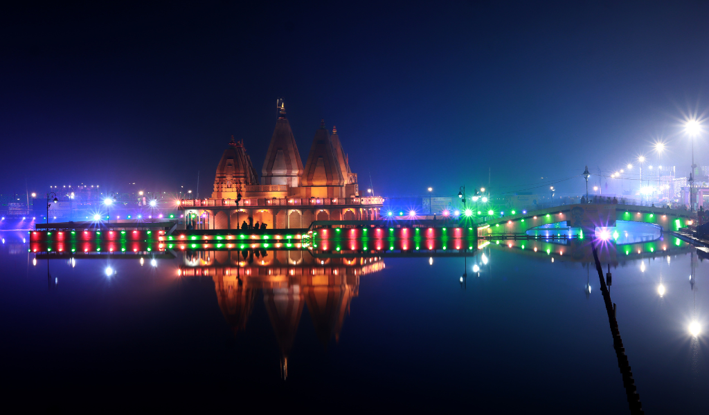 Sarveshwar Mahadev Temple lit up at night across Brahma Sarovar in Kurukshetra