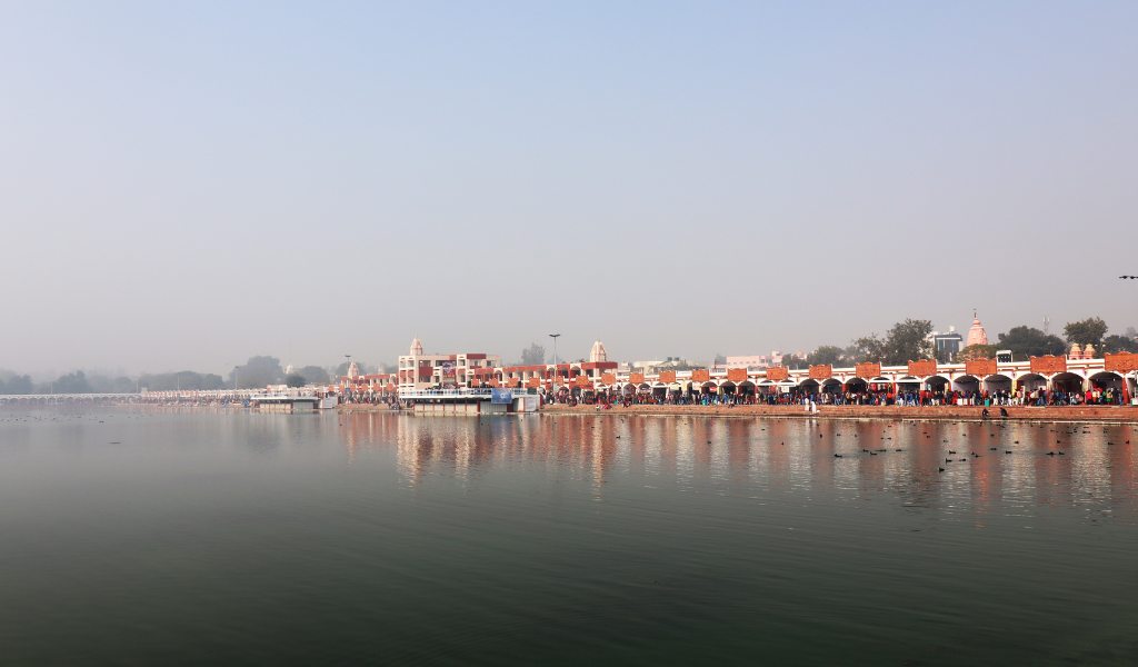 Colorful night lighting and water reflection of temple at Brahma Sarovar Kurukshetra Tour.