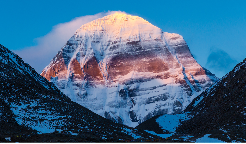 A close-up view of Adi Kailash peak glowing in the golden light of sunset, a highlight from travelers during their Adi Kailash om parvat trek tour package.