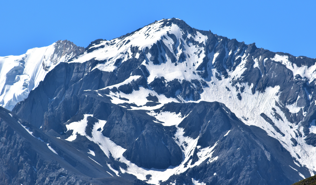 Close-up of the natural snow formation shaped like the OM symbol on the rock face of Om Parvat in Uttarakhand.