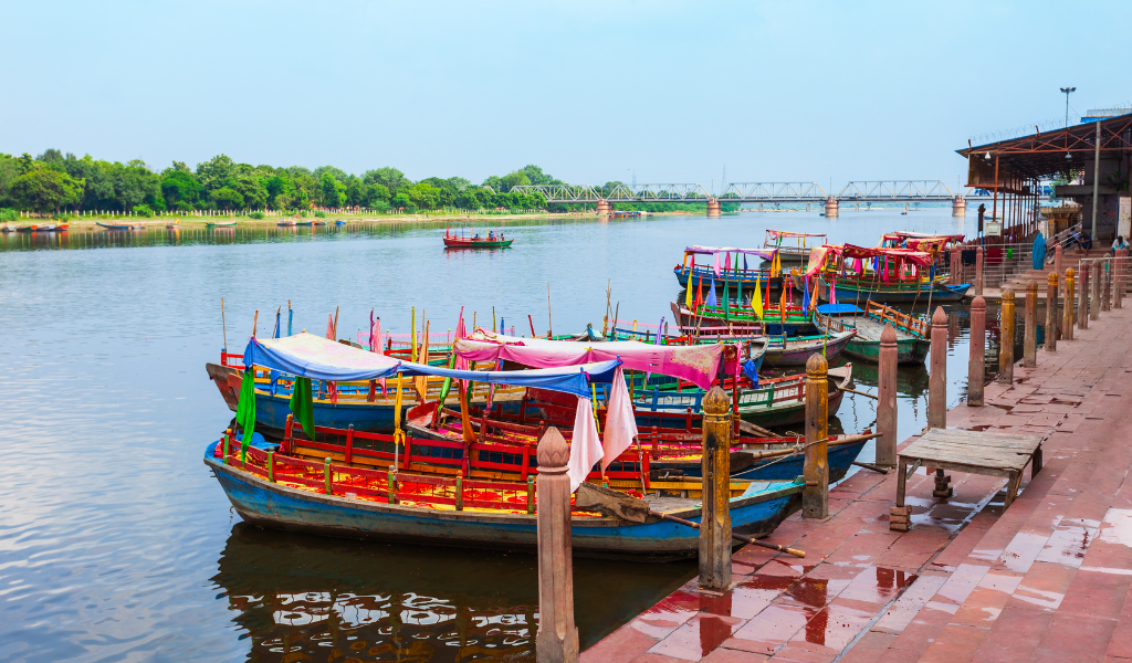 Colorful boats lined up at the Vishram Ghat during a Mathura sightseeing tour included in our Mathura tour package