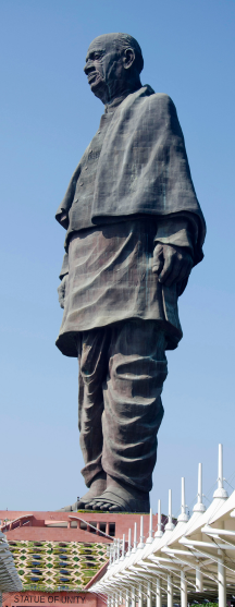 Side view of the massive Statue of Unity of Sardar Vallabhbhai Patel under a clear blue sky in Gujarat. included in gujarat Packages.
