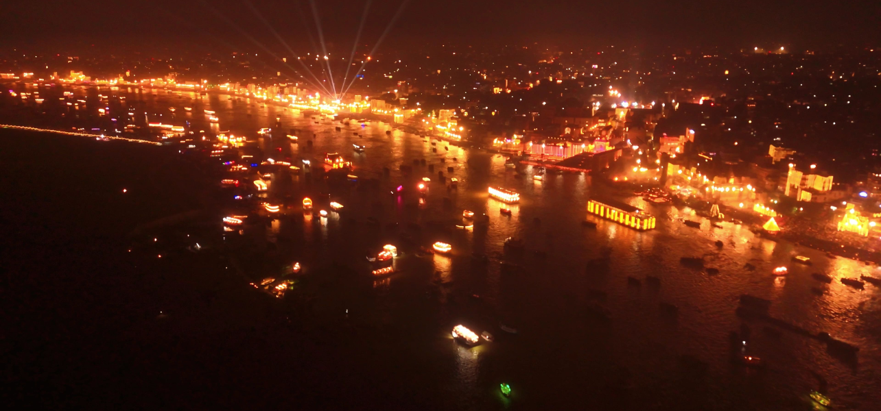 A  aerial view of millions of diyas lighting up the ghats during Dev Diwali, a premium feature of our Varanasi holiday tour package and Kashi Varanasi tour package.