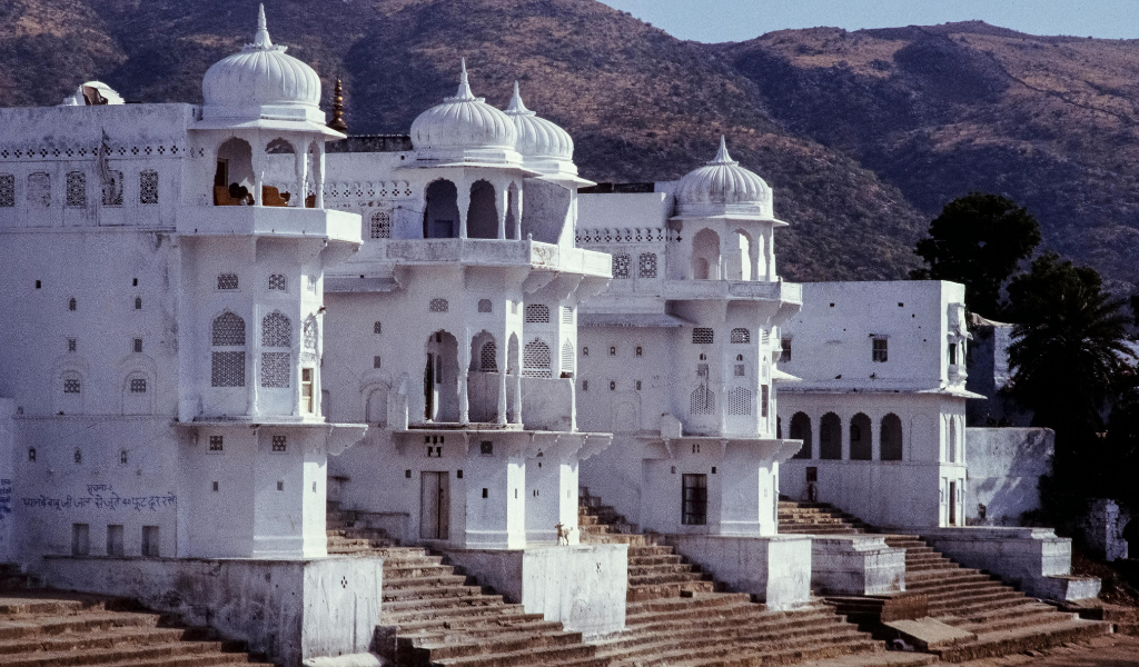 Beautiful white temple architecture in Pushkar Rajasthan with hills backdrop - Pushkar Tour Package highlights