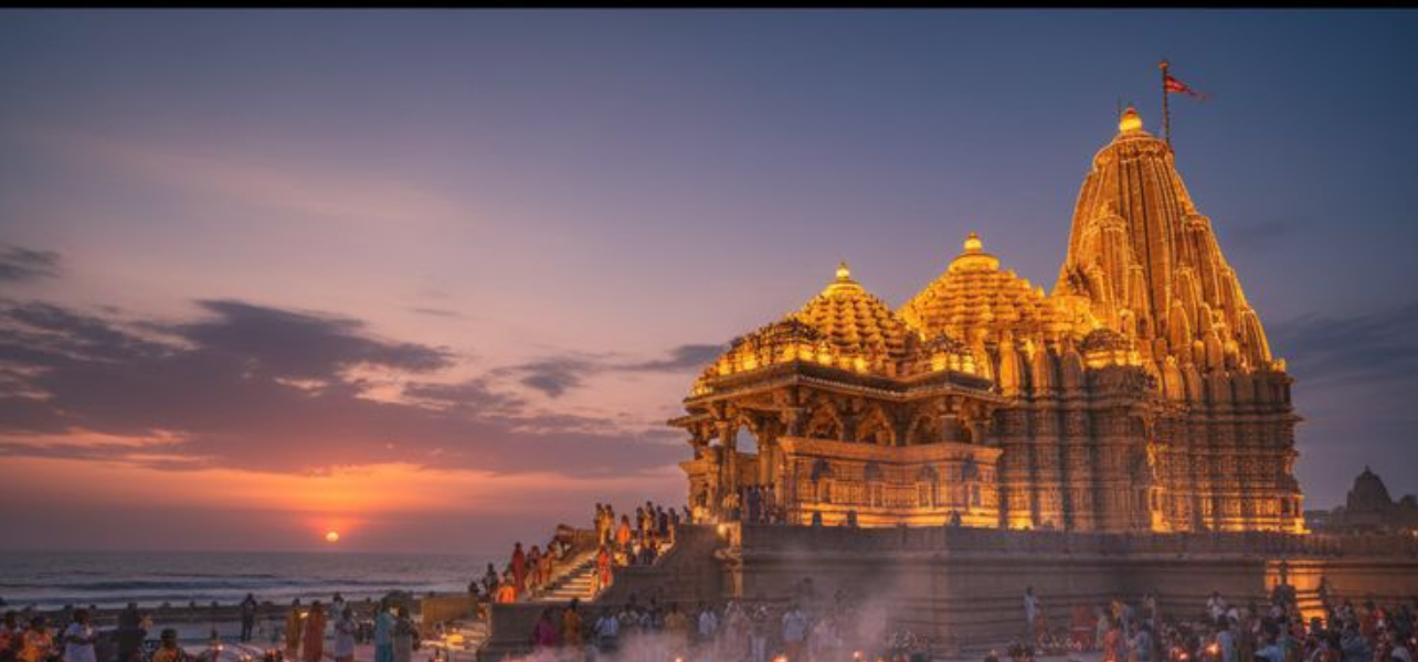 A wide-angle view of the Somnath Temple in Gujarat during sunset, showing a large crowd of devotees participating in the evening Aarti during the Dwarka And Somnath tour.
