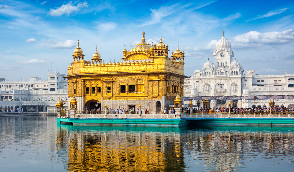 Golden Temple Amritsar Tour Package day view with clear blue sky and reflection in holy sarovar