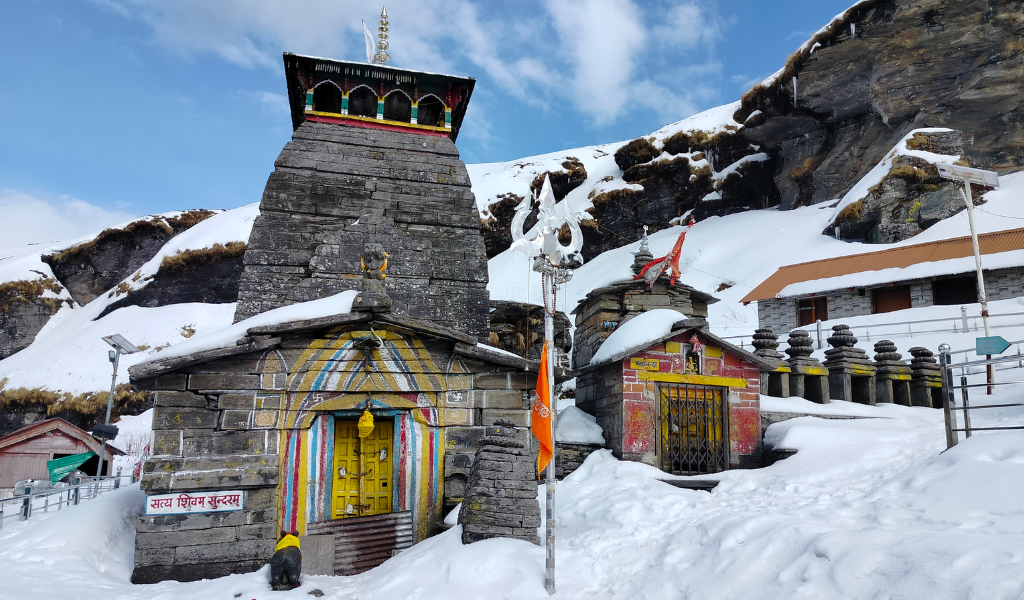 Ancient snow-draped Tungnath Temple featured in a Chopta tungnath trek package.