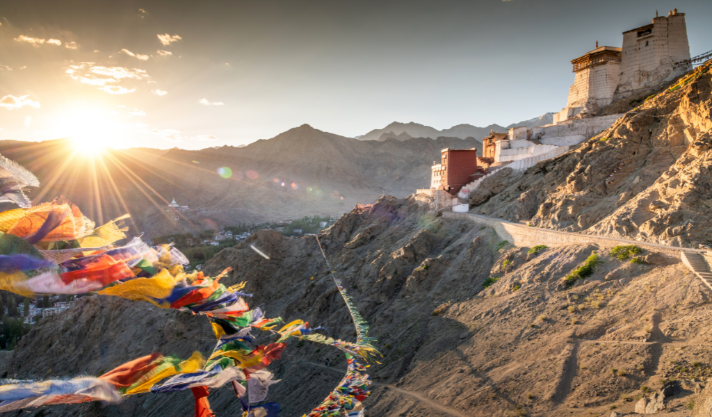 Scenic sunset view in Jammu with colorful flags, mountain road and beautiful valley landscape