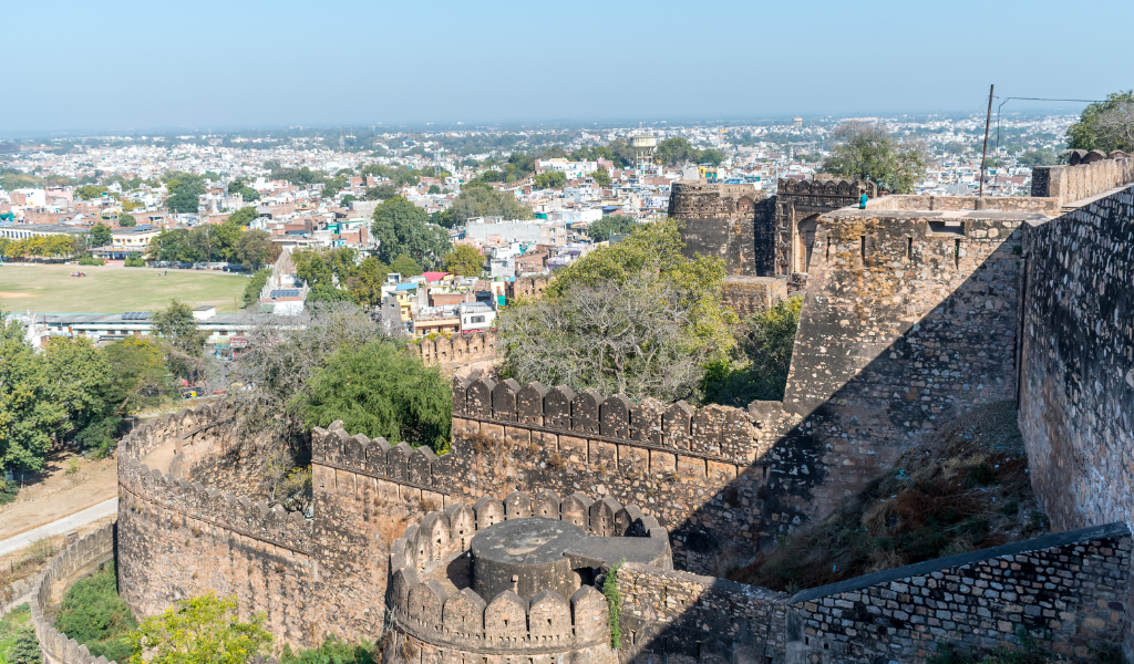 A high-angle panoramic view looking over the ramparts of the Jhansi Fort towards the city, taken during a guided Jhansi tour