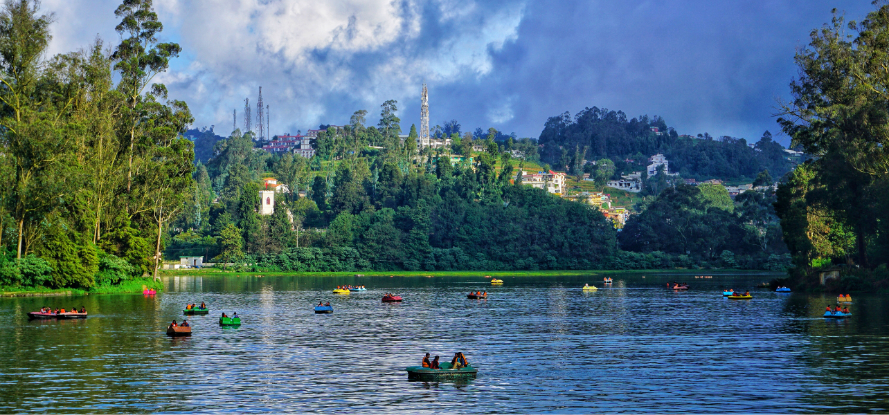 Ooty Tour Packages boating experience at beautiful Ooty Lake surrounded by greenery