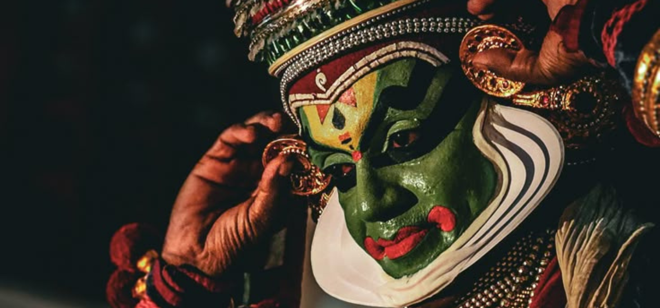 Kathakali classical dance artist from Kerala wearing traditional costume and green face makeup