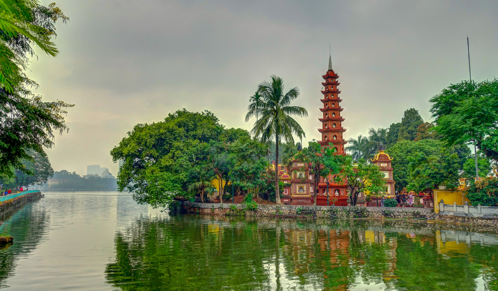 A  view of the historic Tran Quoc Pagoda located on a small island in West Lake, a major Hanoi sightseeing highlight included in this premium Vietnam trip package.