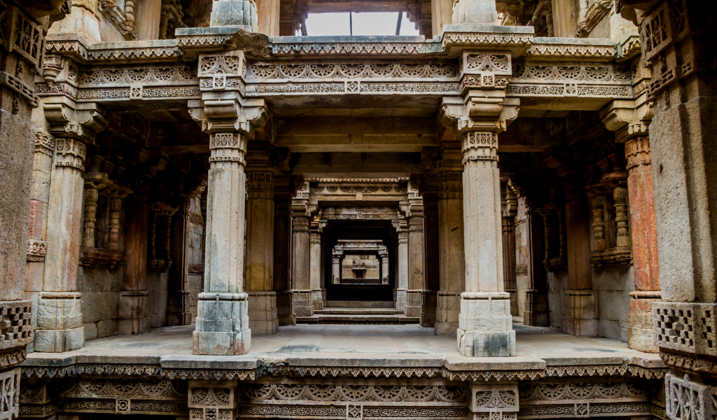 The detailed stone pillars of Adalaj Stepwell, a key attraction in our Gujarat holiday tour package.