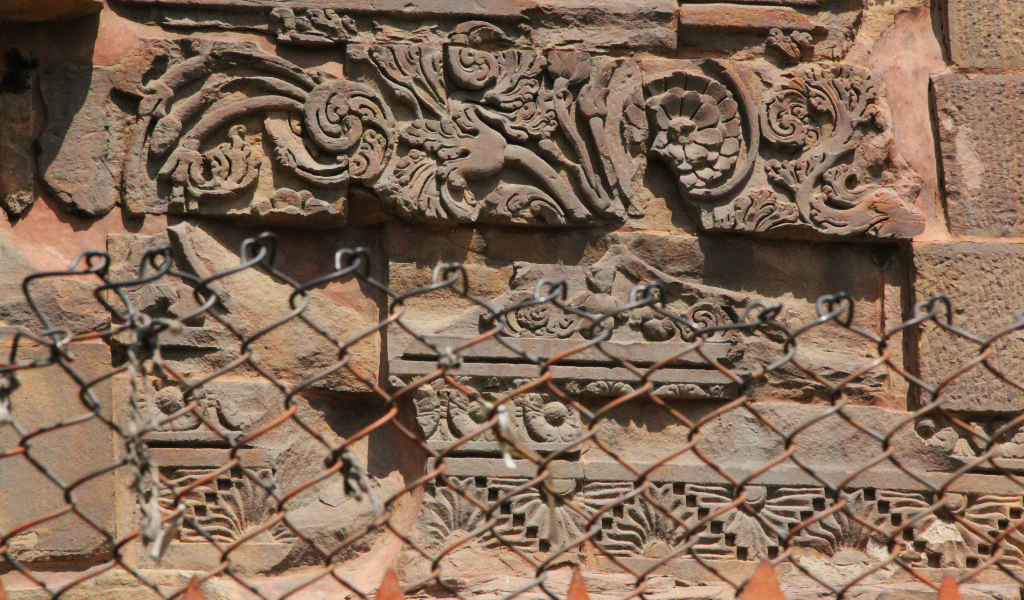 Close-up of historic floral stone patterns and Mauryan era art explored on our expert Sarnath tour package