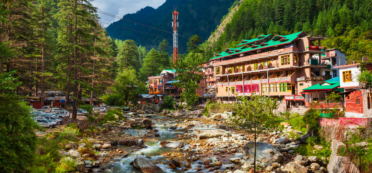 Kasol Tour Package colorful riverside resort view in Himachal Pradesh