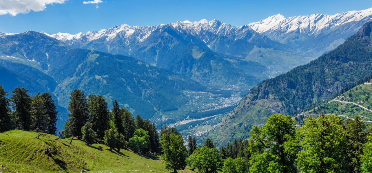 Beautiful view of snow capped Himalayan mountains and green valley for Delhi to Shimla holiday tour package