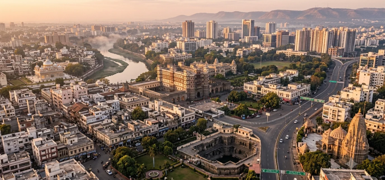 A breathtaking panorama of important Indore sightseeing places including the historic Rajwada Palace, a step-well, and modern buildings in Indore, Madhya Pradesh.