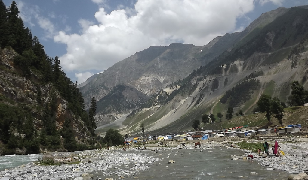 Amarnath Yatra Tour Package scenic mountain valley with river and trekking route