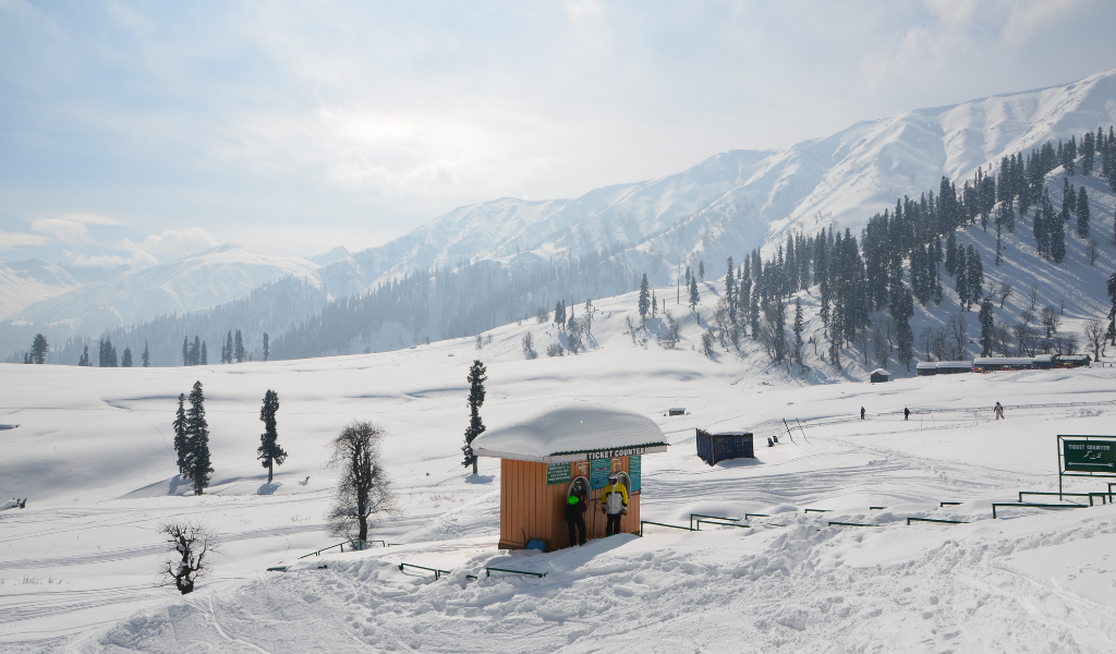 Beautiful snow valley with ticket counter and mountains covered in snow