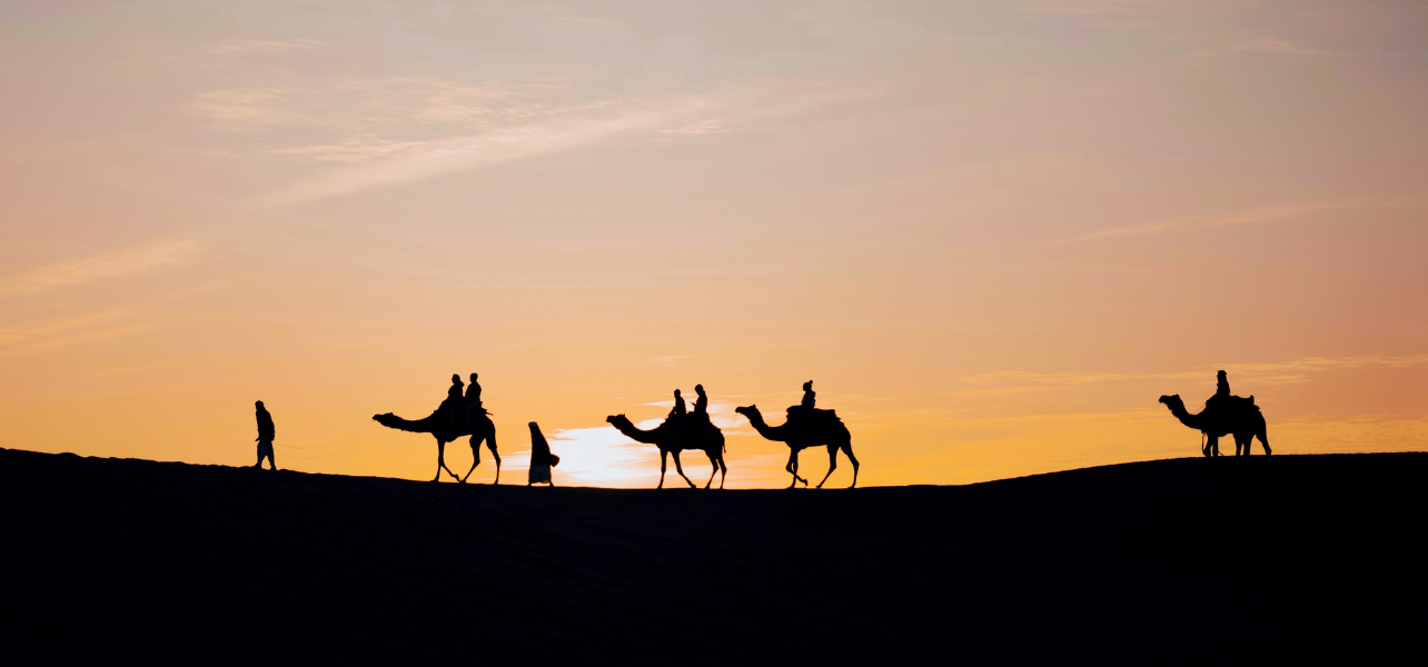 Rajasthan 5 Nights 6 Days Tour Package desert camel caravan during sunset in Rajasthan