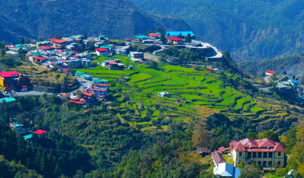 Panoramic valley view and stepped terraced hills featured on a Dehradun tour package
