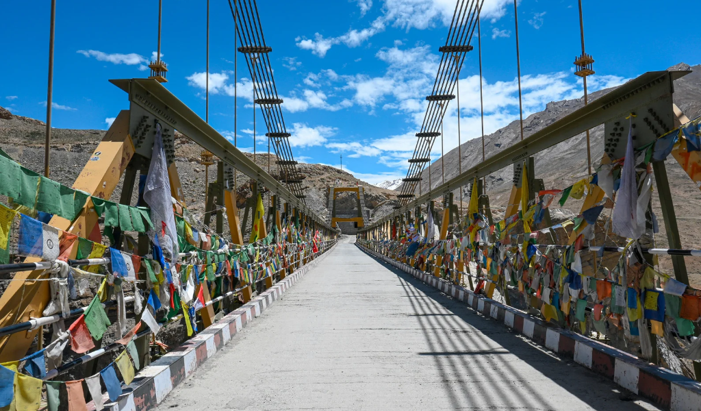 Himalayan valley suspension bridge with Tibetan prayer flags near dharamsala mcleodganj