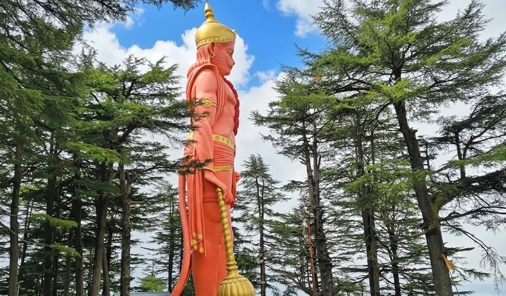 Giant Lord Hanuman statue at Jakhu Hill surrounded by pine trees, one of the famous places to visit in Shimla during sightseeing tours