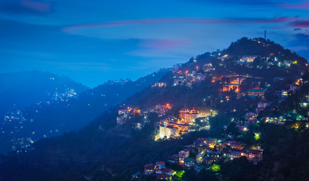 Watch Shimla light up at night! See the beautiful hill town glow at dusk on your Delhi to Shimla holiday package tour.