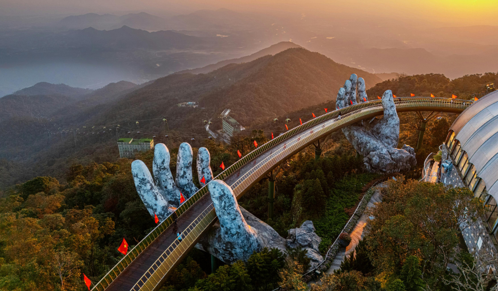 An aerial view of the famous Golden Bridge held by giant stone hands in Ba Na Hills, a must-see in our vietnam travel package and best sightseeing vietnam