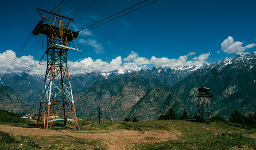 Auli sightseeing ropeway cable car tower offering views of snow-capped Himalayan mountain ranges in Uttarakhand.