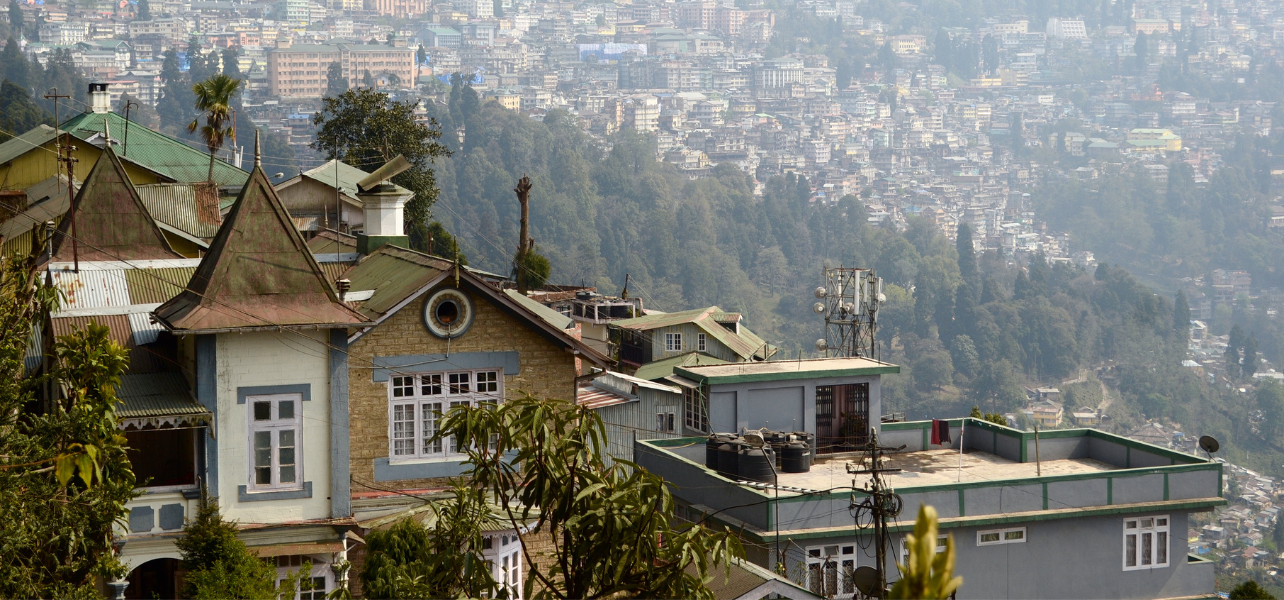 Darjeeling tour Package showcasing beautiful hill town houses and mountain city view