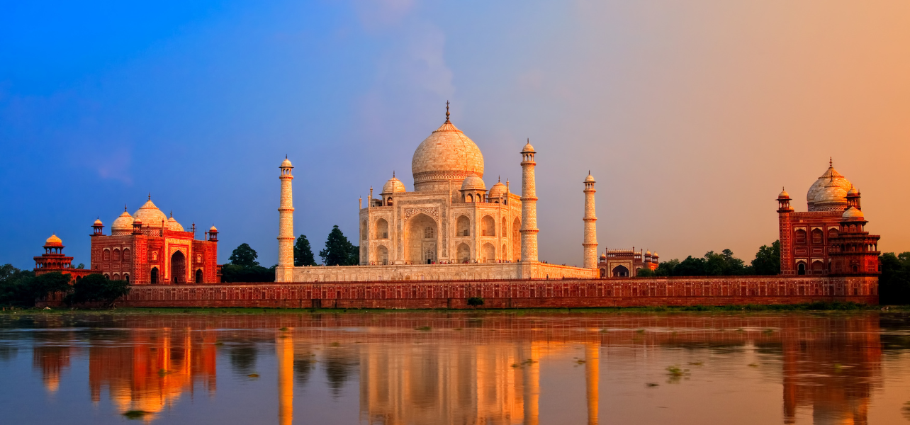 aj Mahal at sunset with reflection in Yamuna River and warm golden light
