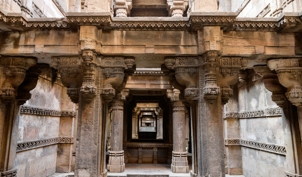 Beautiful stone carvings on old temple pillars that you will see on your Ahmedabad holiday tour package.