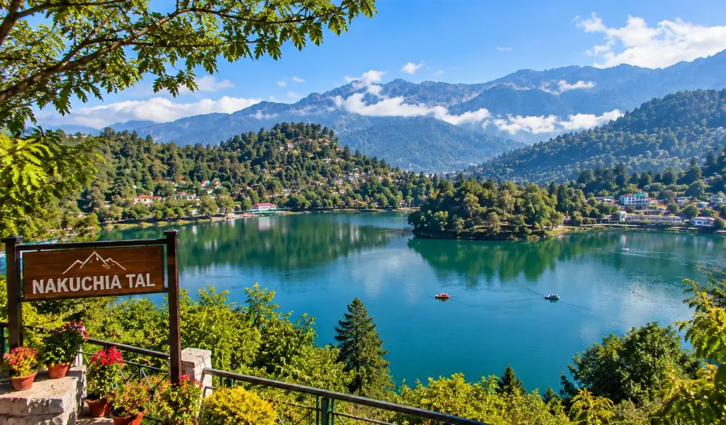 Nainital holiday packages featuring the scenic Nakuchia Tal lake surrounded by lush green hills in Uttarakhand