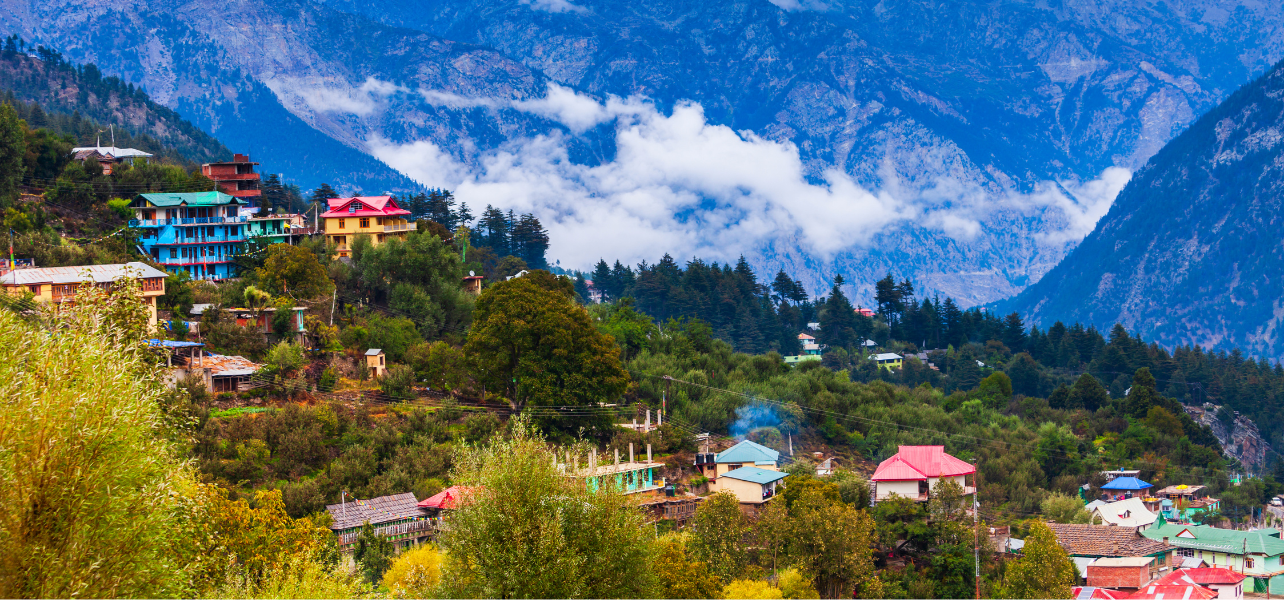 Kullu Tour Package scenic mountain village with colorful houses and Himalayan backdrop