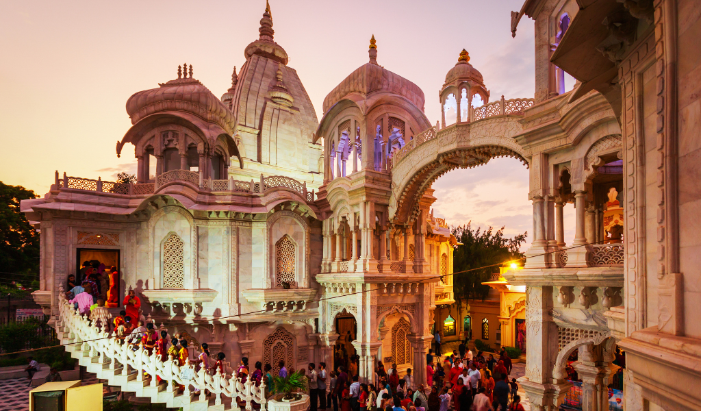 Image of devotees at the white marble ISKCON Temple, captured during  the spiritual journey in our Vrindavan tour package.