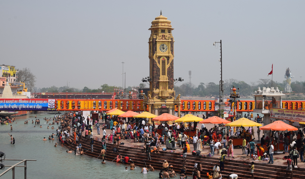 Devotees taking a holy dip at Har Ki Pauri ghat near the clock tower during a Haridwar trip