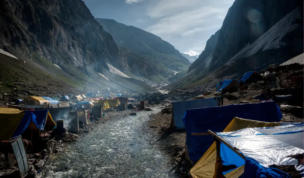 Colorful pilgrim tents pitched along the riverbank at Baltal base camp, the starting point for the Amarnath Yatra trek.