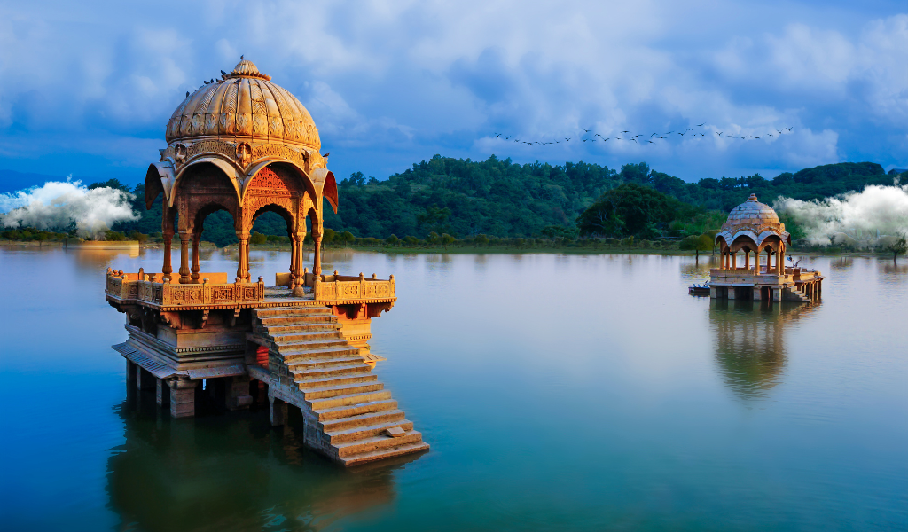 Beautiful view of carved stone pavilions in Gadisar Lake Jaisalmer during a 5N 6D Rajasthan Tour  package