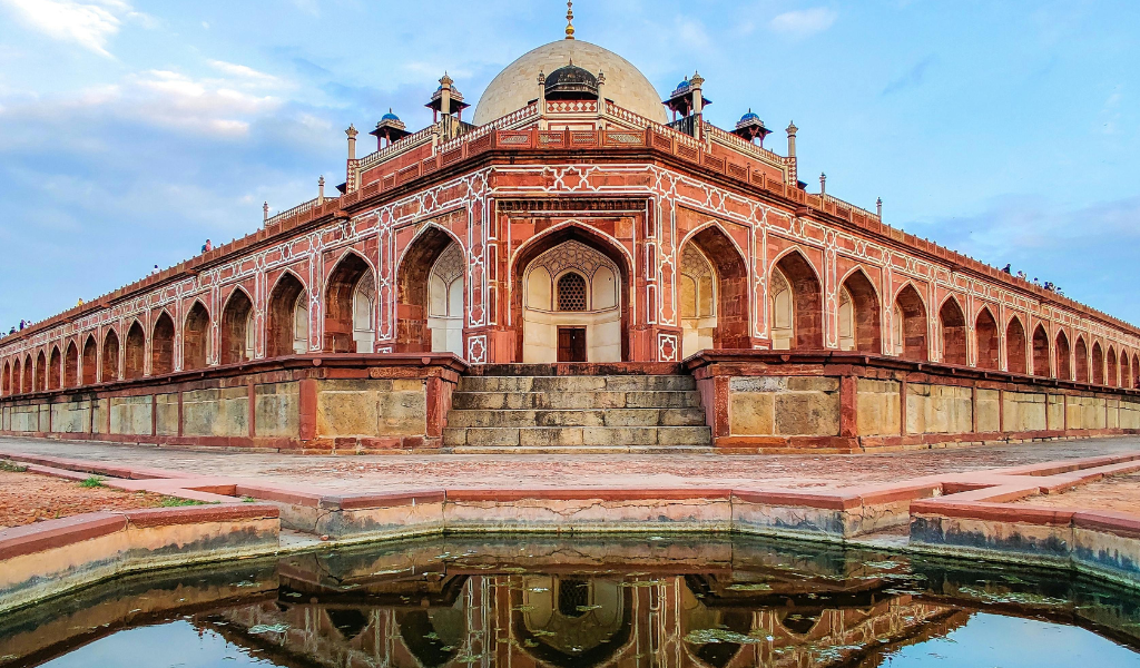 A beautiful old tomb surrounded by green gardens, one of the peaceful heritage stops included in our best Lucknow tour package
